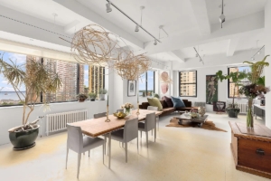 dining room and living room with Hudson views in FiDi loft